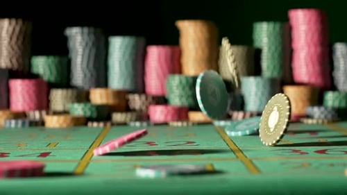 Casino Chips Falling on the Gaming Table on a Black Background with Blurry Stacks Chips
