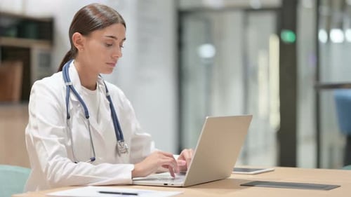Female Doctor Working on Laptop in Office