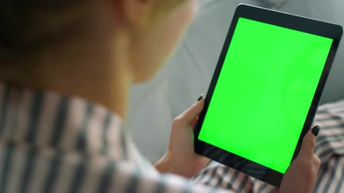 Woman Holding Tablet with Green Screen Display