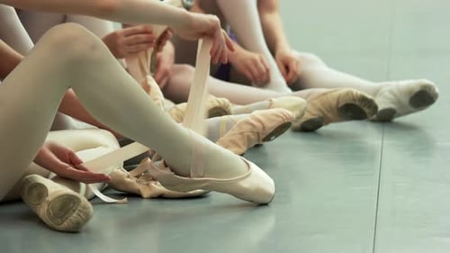 Little Ballerinas Putting on Shoes Close Up