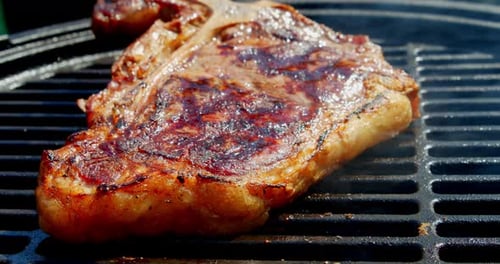 Das duftende Steak T-bone wird mit Rauch gegrillt.