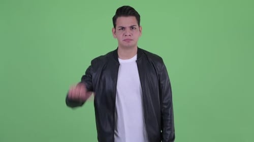 Young Man Gives Thumbs Down on Green Screen