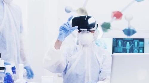 Female Scientis with Coverall Equipment and Virtual Reality Headset Touching in the Air in Modern