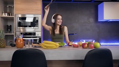Happy Woman Dancing in Modern Kitchen