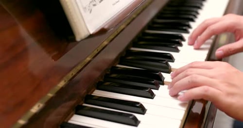 Hands Playing Classical Music on a Wood Piano