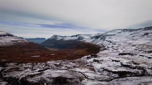Drone Over Snow Covering Landscape With Mountains