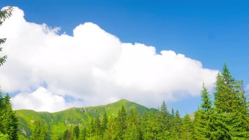 Clouds Over Mountain with Green Grass
