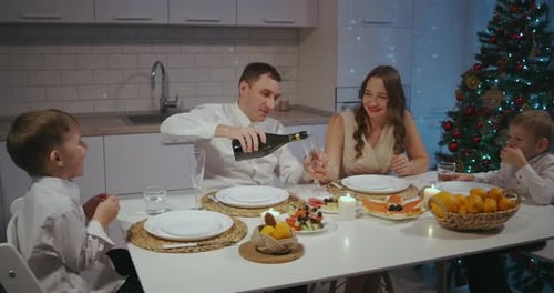 Family Celebrates Christmas at Home with Champagne