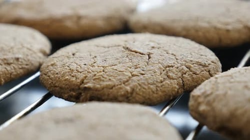 Manicured female hand picks homemade cookie close-up 4K 2160p 30fps UltraHD footage - Picking one b