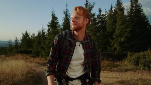 Redhead Man Hiking on Mountain Road
