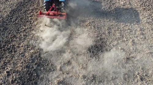 Tractor Tilling Soil in Rural Field Aerial View