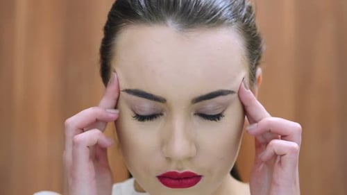 Woman Massaging Temples in Pain Close Up