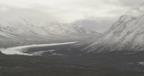 Aerial helicopter shot, flying across vast glacier at golden hour, drone footage