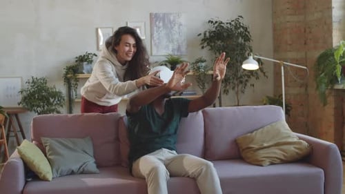 Couple Experiencing Virtual Reality in Apartment