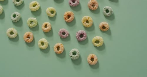 Video of colorful breakfast round cereals on blue background