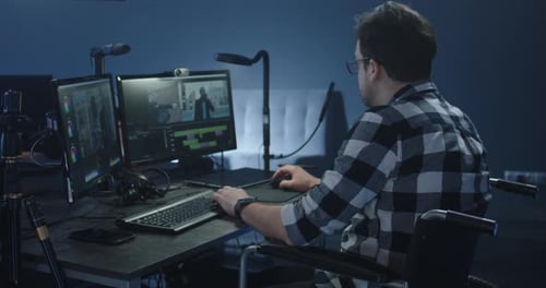 Man in Wheelchair Editing Video at Computer