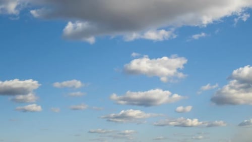 Clouds Float Across a Calm Blue Sky