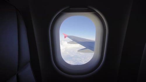 Airplane Flight. Wing of an Airplane Flying Above the Clouds. View From the Window of the Plane