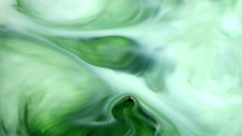 Ink in Water. Green Ink Reacting in Water Creating Abstract Background
