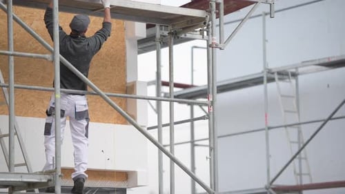 Building Insulation by Caucasian Construction Worker