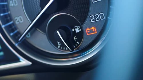 Car Dashboard Displaying Low Fuel and Battery Warning