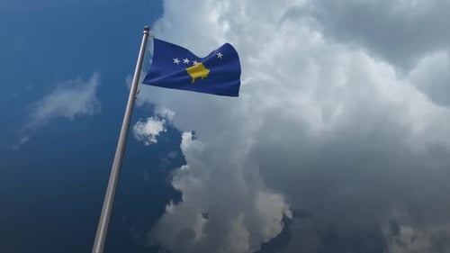 Waving Flag of Kosovo Under Cloudy Sky