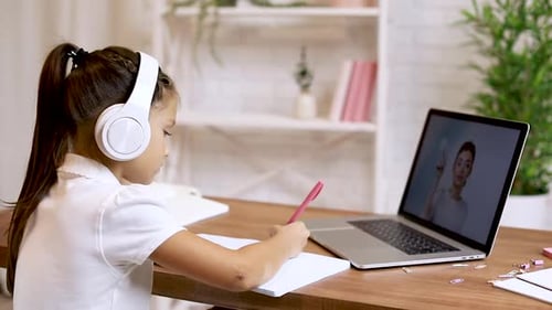 Girl Learning Online with Laptop and Headphones