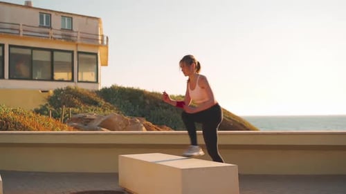 Woman Doing Stepping Exercise at Beachfront