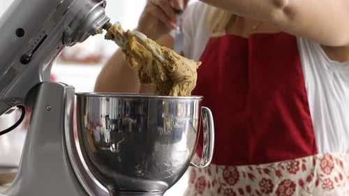 Scooping dough out of electric mixer