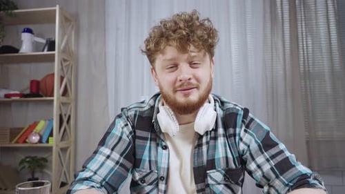 Smiling Young Adult Male in Home Office Speaking