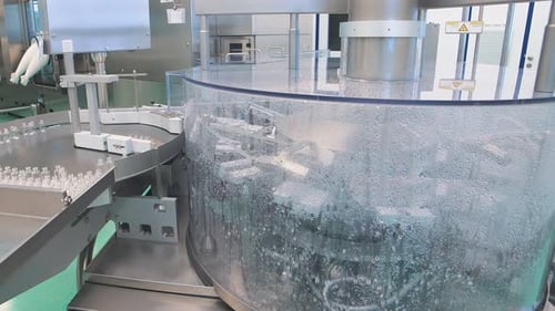 Pharmaceutical Manufacturing Equipment Processing Vials in Clean Factory
