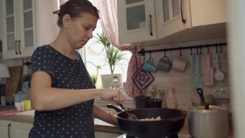 Woman Cooking in Bright Kitchen