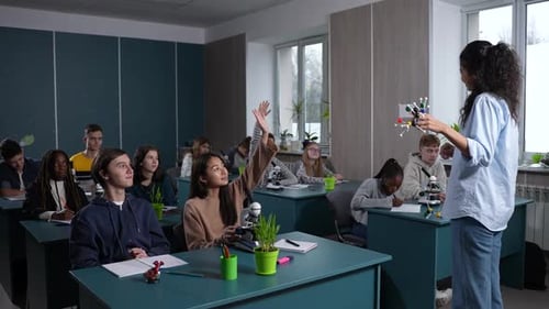 Teacher Presents Molecule Model to Eager Students