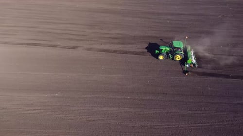 Agricultural Tractor Plows Soil Field for Sowing Aerial Top View From the Drone