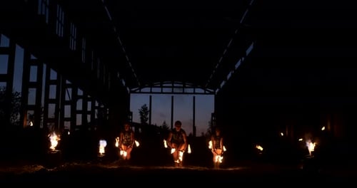 Zeitlupen-Feuershow im Hangar Show Drei Künstlerinnen und einen Mann mit Flammenwerfern