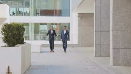 Two Men Walking Outside Corporate Office Building