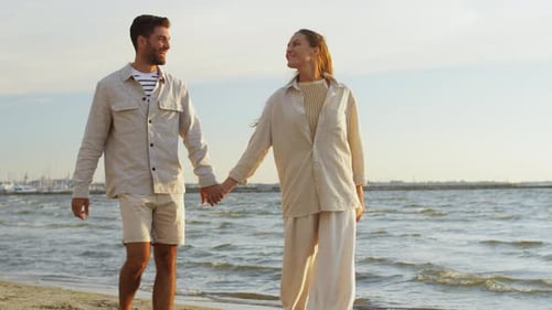 Happy Couple Walking Along Summer Beach