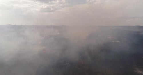 Aerial View Shot Through Smoke From Burning Field