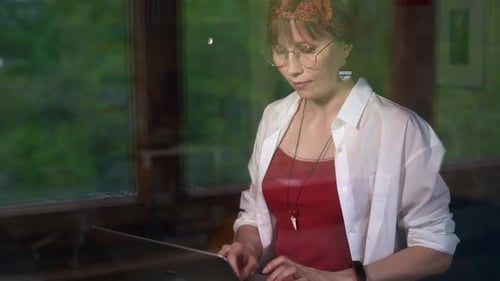 Woman Works on Laptop in Home