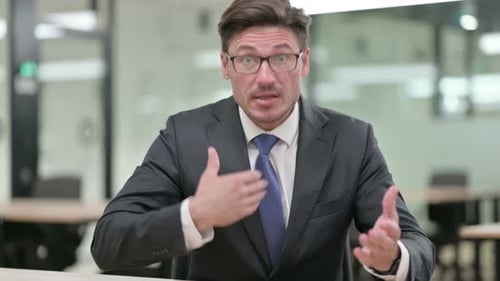 Business Man Talking in an Office Setting