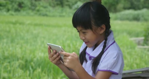 Happy Rural Girl Using Tablet In Cottage