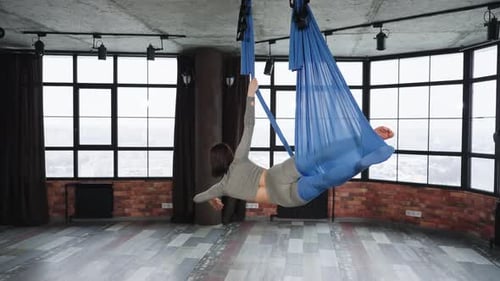 Woman Doing Yoga Pose in Aerial Hammock