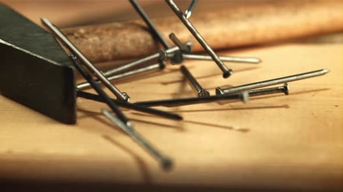 Nails Fall on a Wooden Table