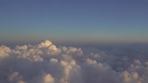 Aerial View of Fluffy Clouds During Golden Hour