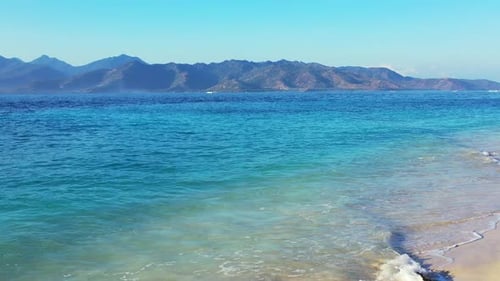 Wide birds eye clean view of a sunshine white sandy paradise beach and turquoise sea background in 4