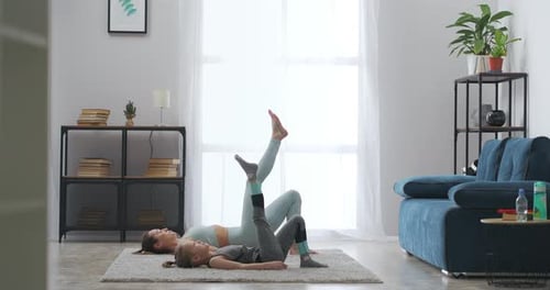 Woman and Girl Practicing Yoga Exercise at Home