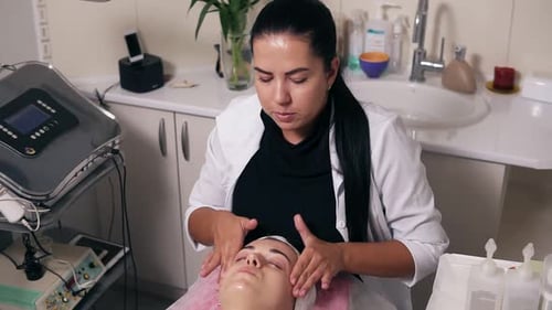 Female Cosmetologist is Making Face Massage in Spa Salon