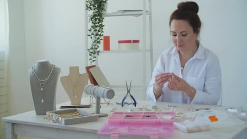 Woman Making Jewelry at Home Worktable