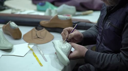 Craftsman Designs Shoes With Leather