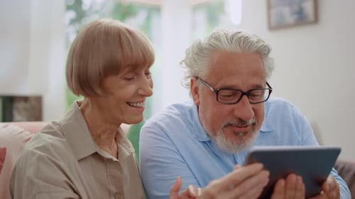 Senior Couple Enjoying a Tablet Together Indoors